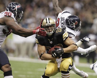 Houston’s Mario Williams (90) and Kareem Jackson attempt to stop New Orleans’ Jimmy Graham during the second half of the Saints’ victory. (Associated Press)