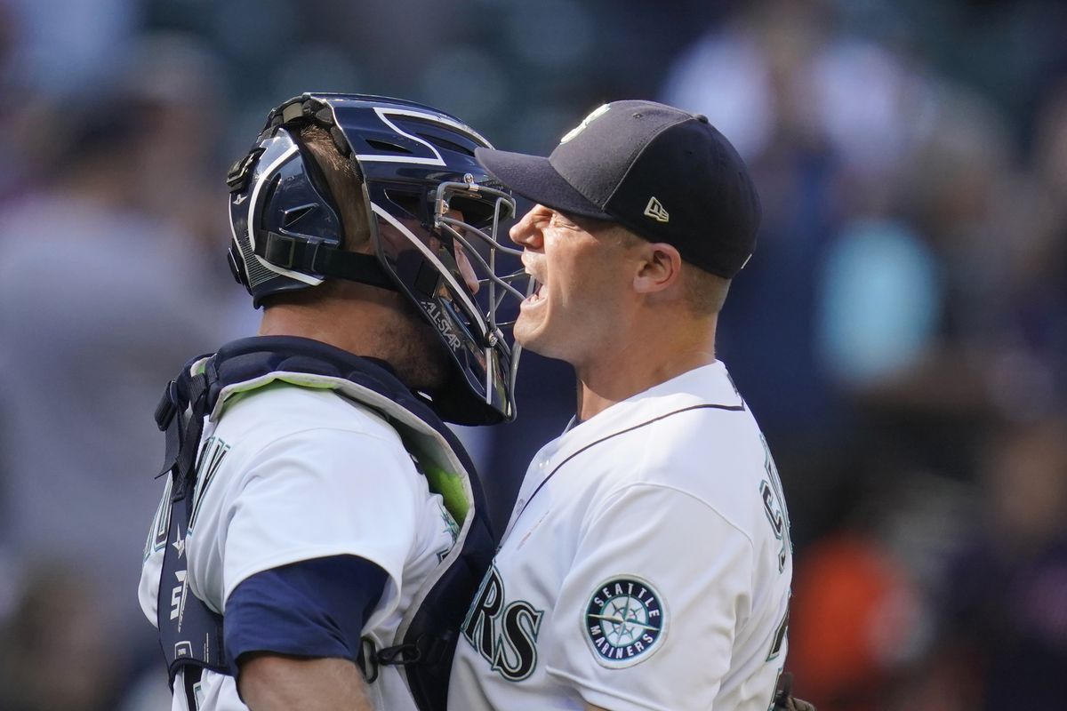Mariners reliever Paul Sewald, right, is congratulated by catcher Tom Murphy after Seattle defeated the Houston Astros 1-0 Wednesday afternoon at T-Mobile Park.  (Associated Press)