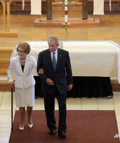 Former first lady Nancy Reagan is escorted by former President George W. Bush following the funeral for former first lady Betty Ford on Tuesday in Palm Desert, Calif. (Associated Press)