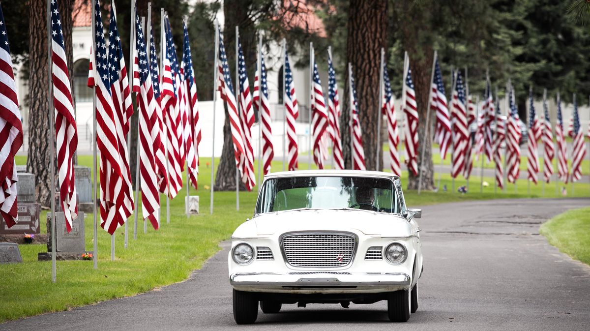 A classic car near the end of a vehicle parade through Riverside Memorial Park catches up to other classic cars on Memorial Day, May 25, 2020 in Spokane, Wash. The motorcyle riders were followed by classic cars and then contemporary vehicles with visitors, reducing the amount of people walking on the grounds. (Libby Kamrowski / The Spokesman-Review)