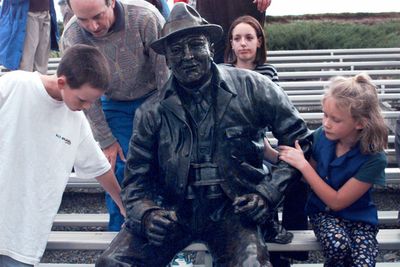 When the statue of Joe Fan was unveiled at Albi Stadium in 1997, Bill Albi, left, and his sister, Sarah, were there to check it out. Artist Vincent DeFelice used their ancestor, Joe Albi, as the model for the tribute to fans and the stadium.  (File / The Spokesman-Review)