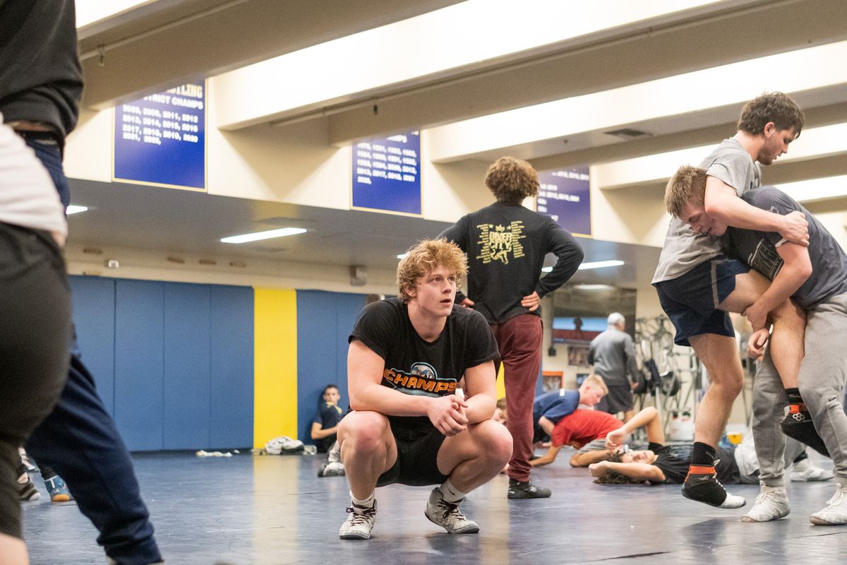 Senior wrestler Chris Grosse watches action during Monday’s practice at Mead High School.  (Madison McCord/For The Spokesman-Review)