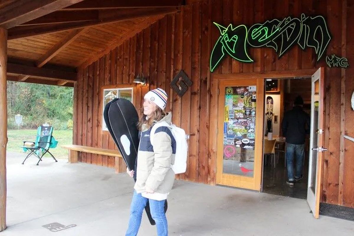 Former Olympic snowboarder Barrett Christy Cummins, who is sponsored by the GNU brand, stops by Mervin Manufacturing in Sequim to pick up a new board in November 2022.  (Gregory Scruggs/The Seattle Times)