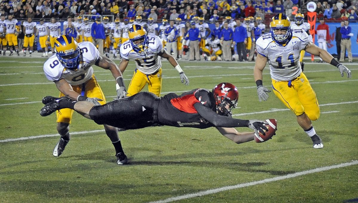 EWU wide receiver Brandon Kaufman stretches out into a full dive to get across the goal line and score on a 2-yard pass from quarterback Bo Levi Mitchell. The play earned EWU its first touchdown en route to a 20-19 win in the FCS national championship game against Delaware in Frisco, Texas.  (Christopher Anderson)