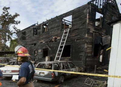 
Firefighters work at the scene of a fatal fire at a four-unit apartment complex in Yakima on Monday. Two people died, and the cause of the fire is under investigation. Associated Press
 (Associated Press / The Spokesman-Review)