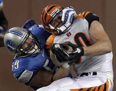 Detroit Lions linebacker Bobby Carpenter brings down Cincinnati Bengals tight end Chase Coffman. (Associated Press)