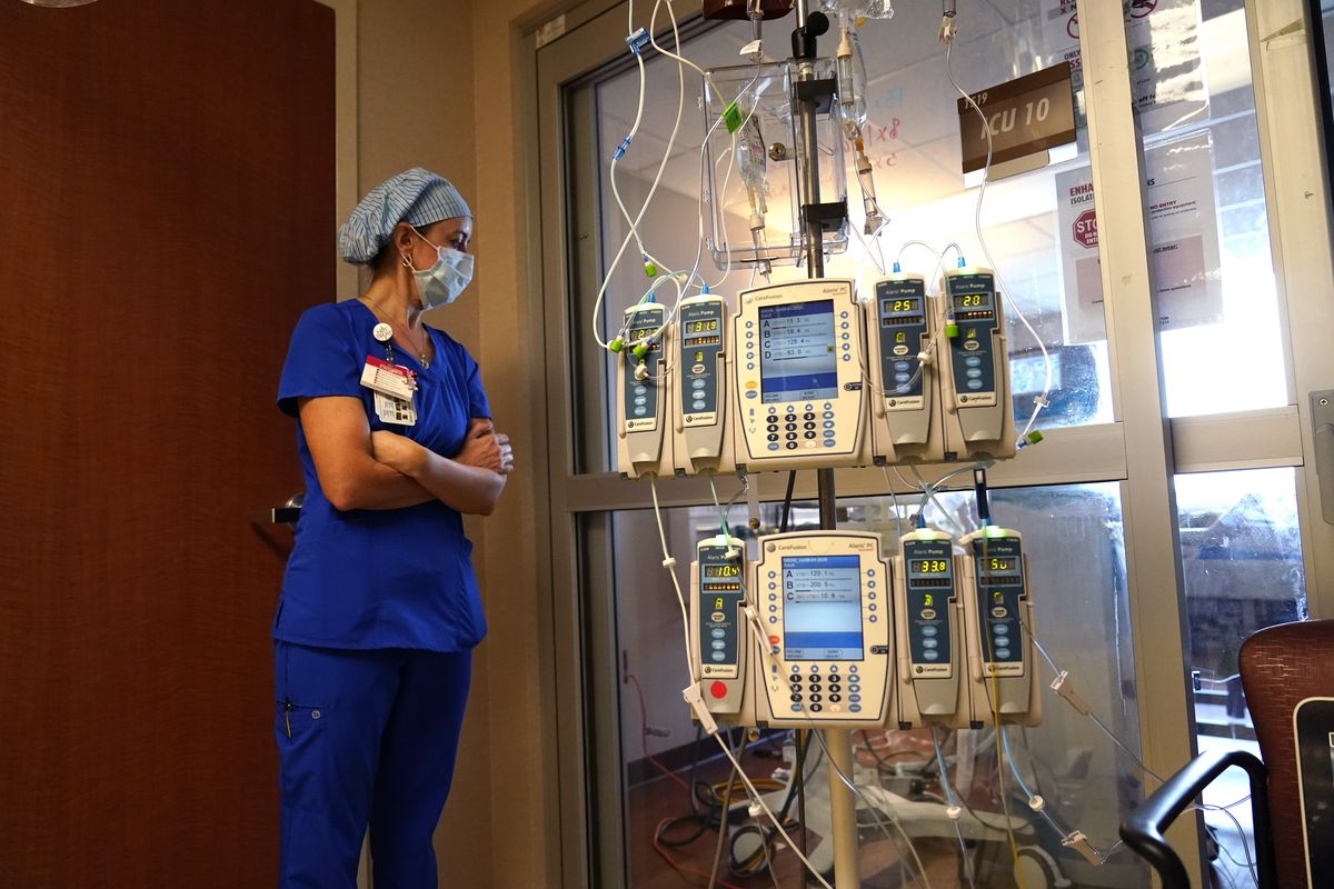 In this Aug. 17, 2021, file photo, nursing coordinator Beth Springer looks into a patient