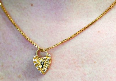 
This delicate gold charm, dated 1897, was an estate sale find. 
 (Ingrid Lindemann / The Spokesman-Review)