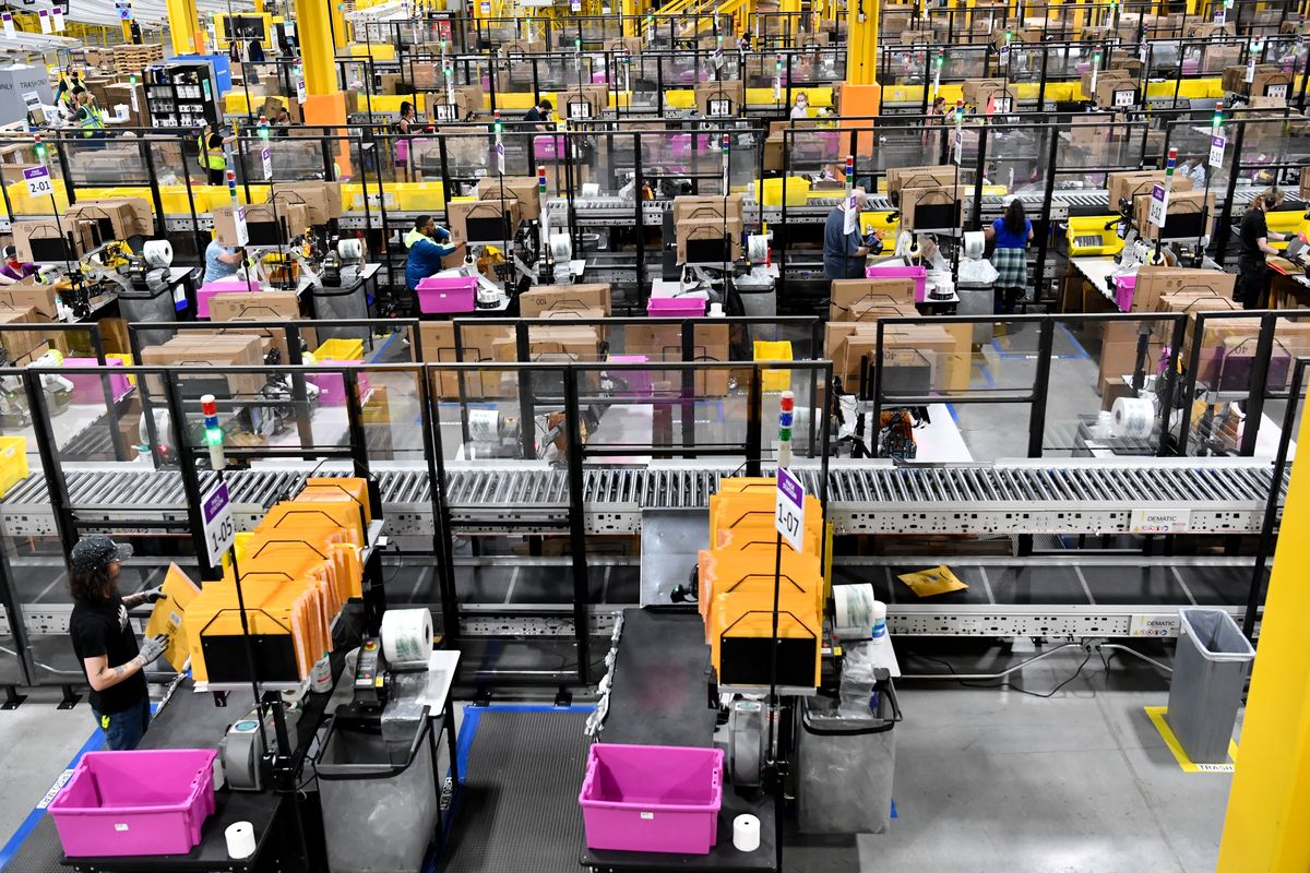 Amazon employees package items at the Amazon Fulfillment Center in Airway Heights on June 7, 2021.   (Tyler Tjomsland/The Spokesman-Review)