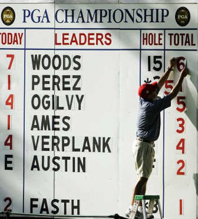 
The leaderboard tells the tale as a worker changes Tiger Woods' total during Friday's second round. Associated Press
 (Associated Press / The Spokesman-Review)