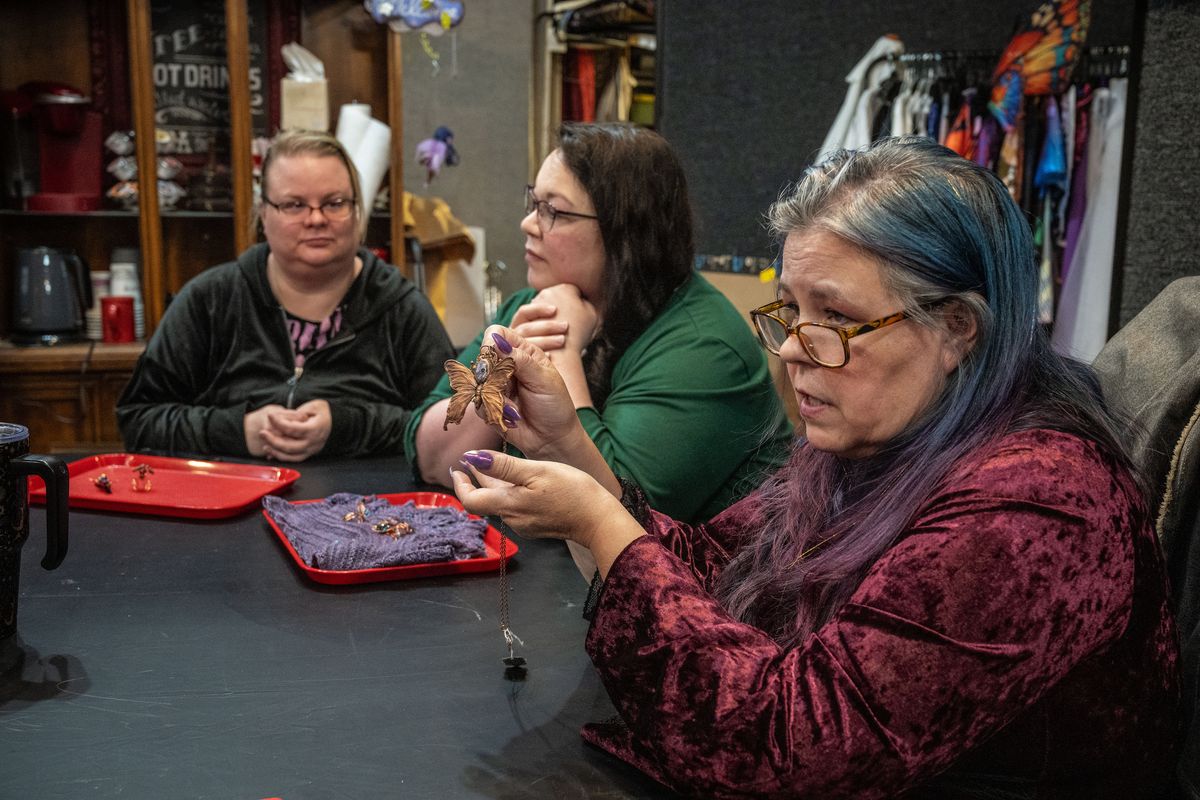 Holly Swanson shows the group her electroformed–copper-plated pendent made from a real butterfly during a monthly meeting of the Spokane Jewelers Guild, a professional organization of artisan jewelers founded in 1982. The group promotes the craft of fine-art jewelry-making through monthly meetings, educational programs and community service.  (COLIN MULVANY/THE SPOKESMAN-REVIEW)
