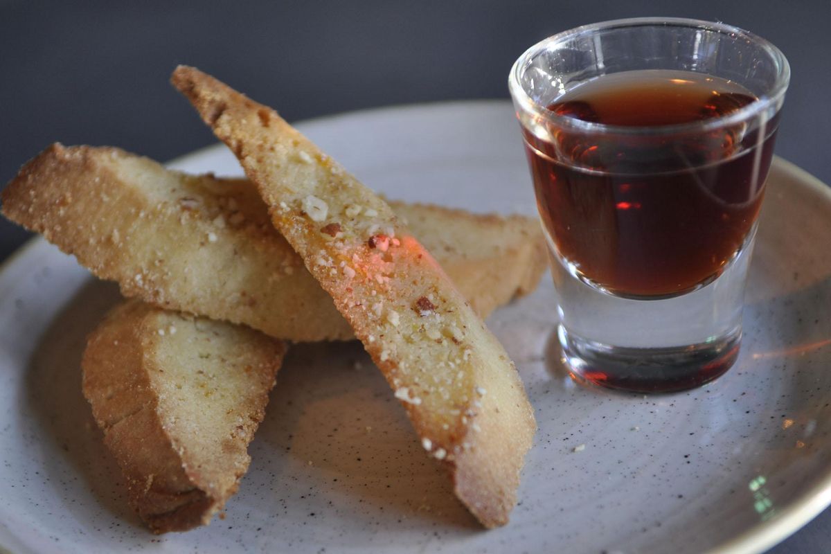 One of Naomi Boutz’s favorite desserts is biscotti with a shot of tawny port. She often serves this dish to guests at her home, and it’s now on the menu at her new restaurant and wine bar, Vine and Olive, in the Riverstone development in Coeur d’Alene. (Adriana Janovich / The Spokesman-Review)