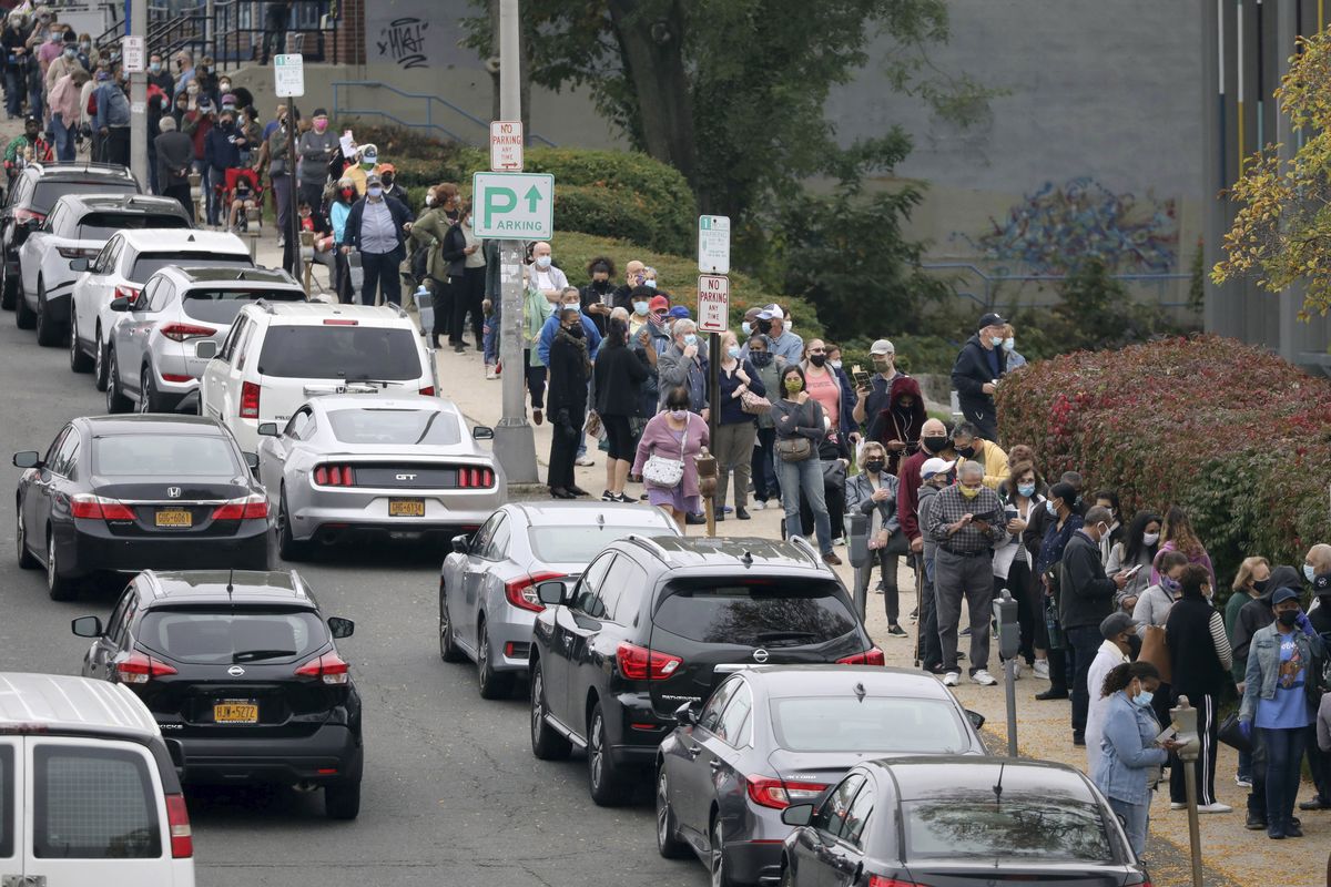 Voters line up in front of the Yonkers Public Library in Yonkers, N.Y., on Saturday, Oct. 24, 2020 as the first day of early voting in the presidential election begins across New York state.  (Mark Vergari)