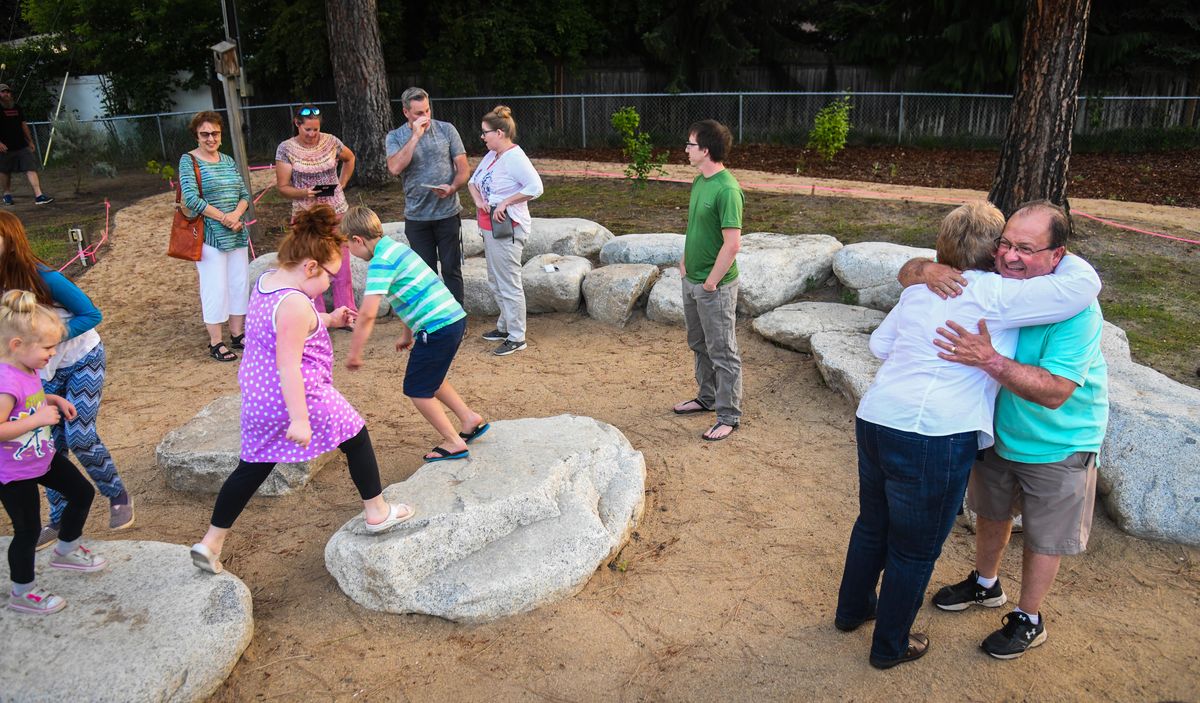 Ron Brooks, right, welcomes friends to the opening ceremony for the living classroom at Evergreen Elementary School in the Mead School District, Friday, June 8, 2018. The Living Classroom was dedicated in memory of his father and Evergreen principal Harry Brook who died in 1975. (Dan Pelle / The Spokesman-Review)