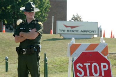 
West Virginia state Trooper Brian Ward blocks the entrance to the Tri-State Airport in Ceredo, W.Va., on Thursday. 
 (Associated Press / The Spokesman-Review)