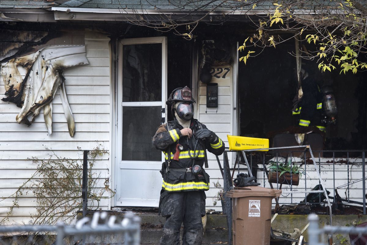 Spokane Fire Department crews work the scene of a fatal house fire at 1227 E. Longfellow Ave. on Tuesday morning. (Dan Pelle)