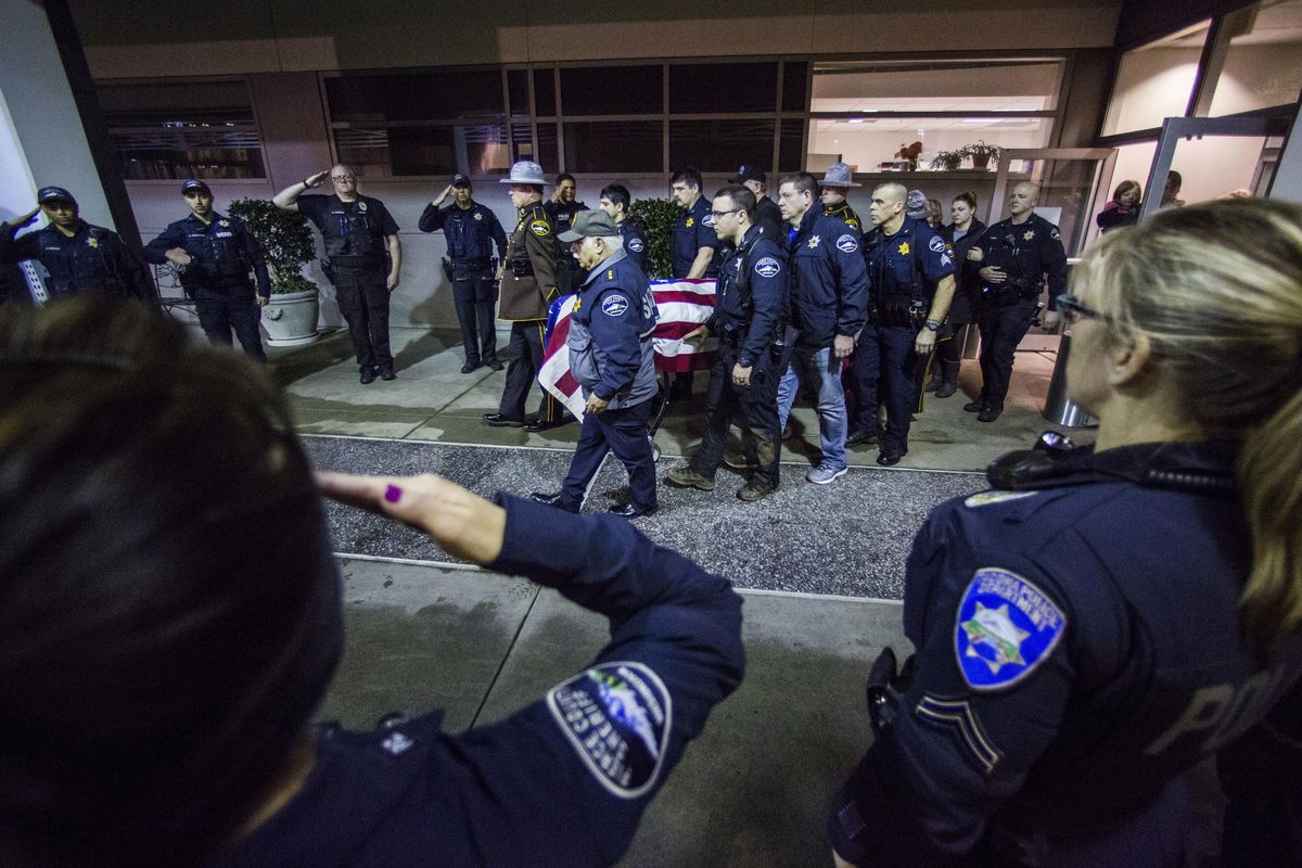 Officers and medical staff take part in a procession for officer Daniel McCartney, of Yelm, at St. Joseph Medical Center in Tacoma, Wash., on Monday, Jan. 8, 2018. The department said McCartney was responding to a home invasion in the Frederickson area, late Sunday night when he was shot during a foot chase. (Joshua Bessex / Associated Press)