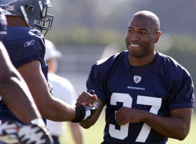 
Seattle Seahawks running back Shaun Alexander, right, is greeted by teammate and offensive tackle Sean Locklear during his first day of training camp Monday at Eastern Washington University. 
 (Associated Press / The Spokesman-Review)