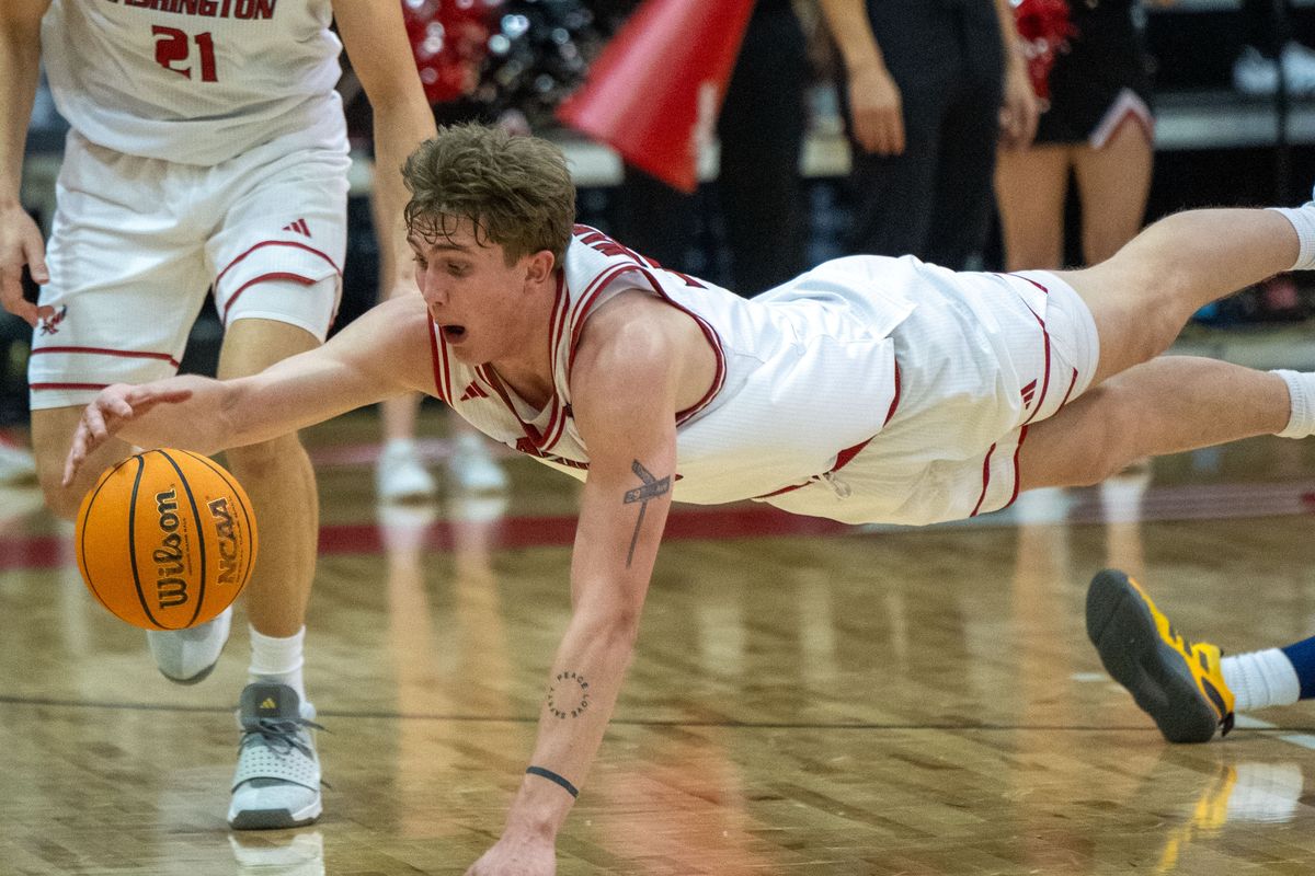 Eastern Washington forward Emmett Marquardt (33) dives for a loose ball during the first half of a college basketball game with Northern Arizona, Thursday, Jan. 23, 2025, in Cheney.  (Colin Mulvany/The Spokesman-Revi)