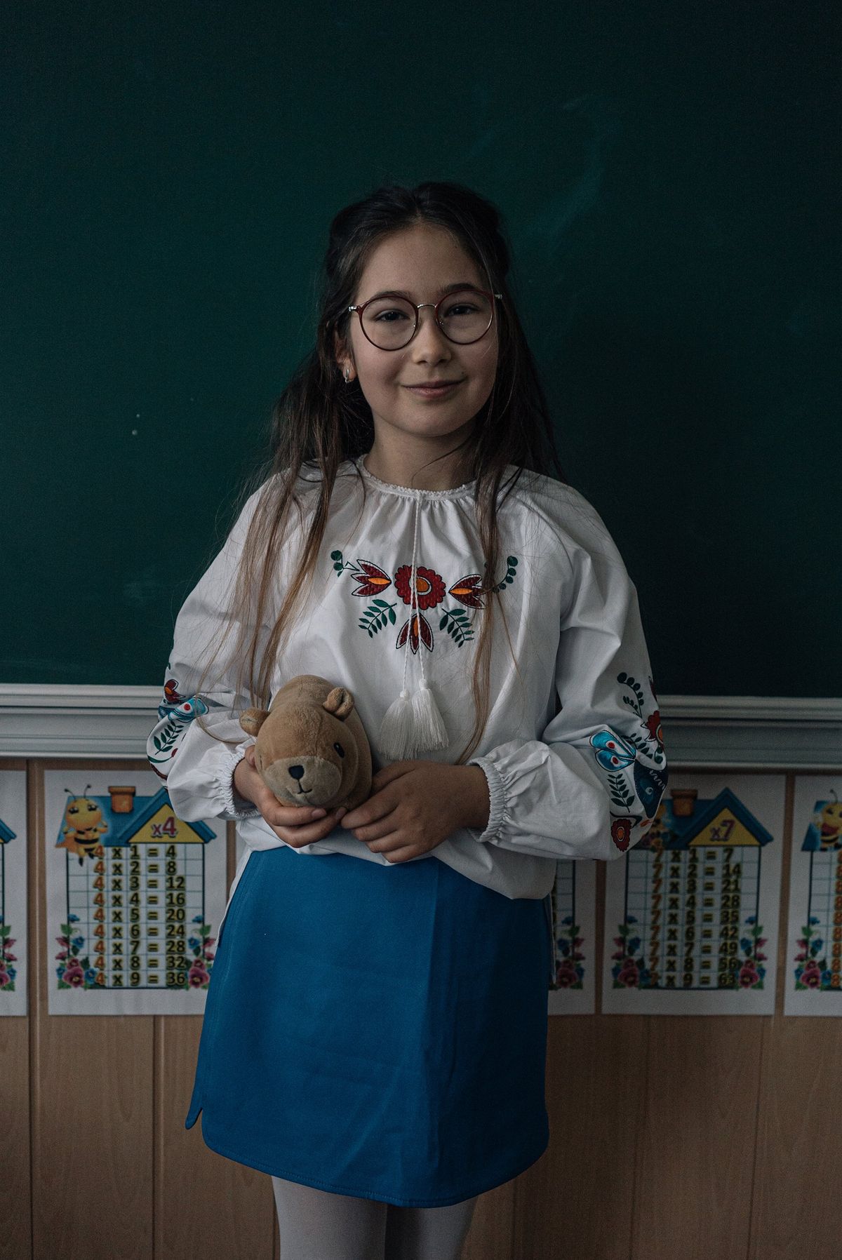 Kate, 10, holds her stuffed capybara, named Capi. "I feel happy and good," she said of being back in Bucha after fleeing with her mom and brother earlier in the war.    (Alice Martins/For The Washington Post)