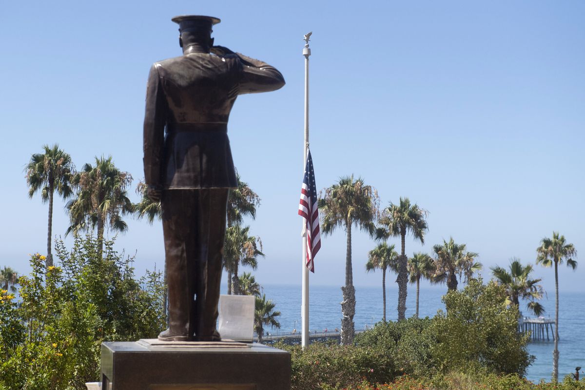 The U.S. flag was lowered to half-staff at Park Semper Fi in San Clemente, Calif., on Friday, July 31, 2020. Officials say a military seafaring assault vehicle with 15 Marines and a Navy sailor aboard sank off the coast of Southern California, leaving one of the Marines dead and eight missing. A Marine Corps spokesman says they were traveling in the amphibious assault vehicle from the shores of San Clemente Island to a Navy ship Thursday evening when they reported that the vehicle was taking on water.  (Paul Bersebach)