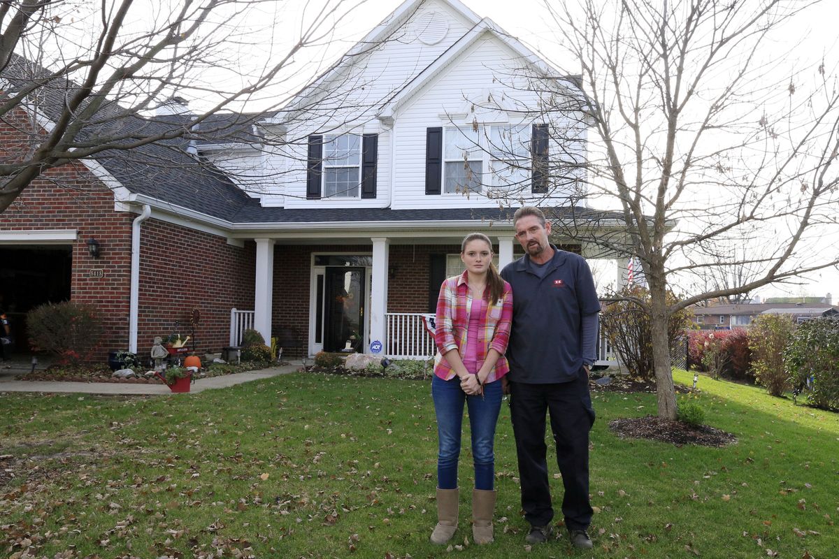 Barry Chipman, right, poses for a portrait with his daughter Billie, 16, in front of their home in Indianapolis Thursday, Nov. 15, 2012. The Chipman