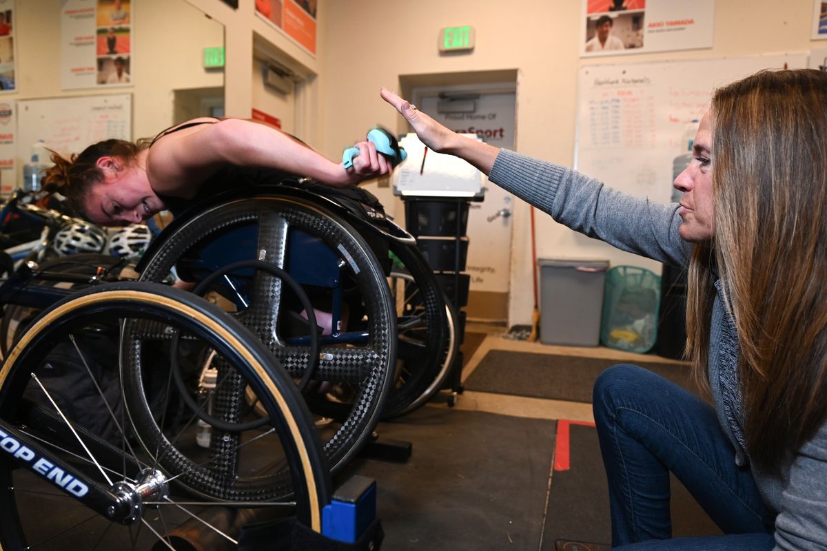 Teresa Skinner conducts training Nov. 17 at ParaSport Spokane’s rented space at Valley Christian School with wheelchair racer Jessica Bellefeuille, left, who works out on a stationary trainer.  (JESSE TINSLEY/THE SPOKESMAN-REVIEW)