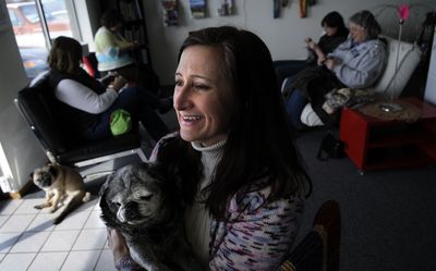 Andrea Rainey along with her 14-year-old Pug, Marley, at her shop, CDA Yarn and Fiber.  (Kathy Plonka / The Spokesman-Review)