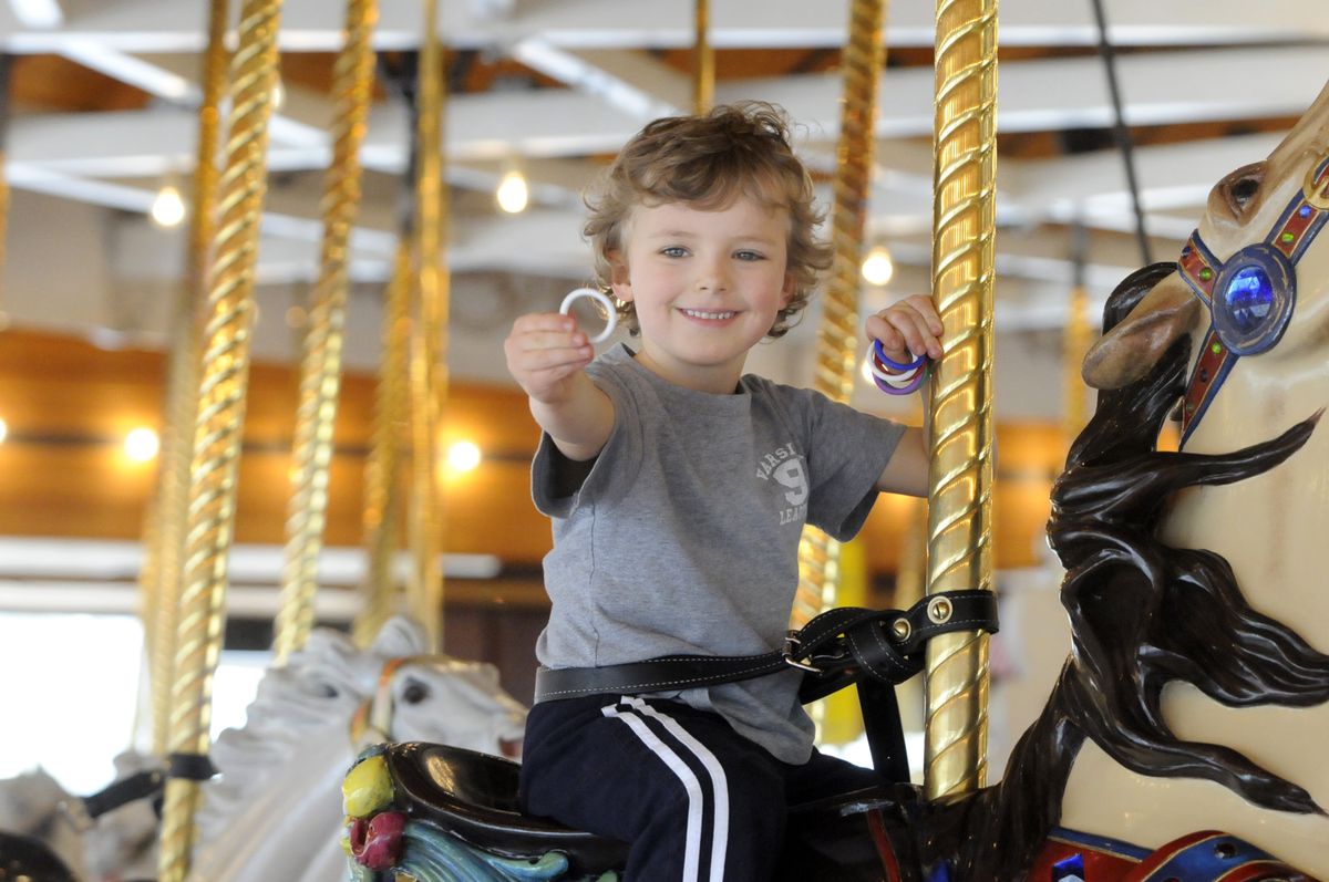 A century later, the Looff Carrousel still brings smiles to the faces of riders of all ages. (Jesse Tinsley / The Spokesman-Review)