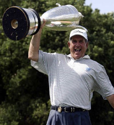 
Jay Haas holds the trophy over his head as he celebrates winning the Senior PGA. 
 (Associated Press / The Spokesman-Review)