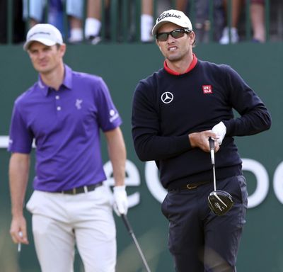 In this July 18, 2014,  photo, Adam Scott, of Australia, watches his shot off the first tee with Justin Rose, of England, during the second day of the British Open Golf championship at the Royal Liverpool golf club, Hoylake, England. Scott and Rose gained PGA Tour membership on the same day, with Scott winning TPC Boston and Rose third. These longtime friends have now surpassed $50 million in career earnings on the same day, this time with Rose winning at Torrey Pines. (Jon Super / Associated Press)