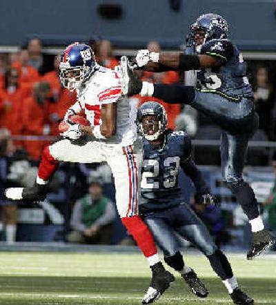 
Safety Marquand Manuel, upper right, has stepped in alongside regulars such as Marcus Trufant (23). 
 (Associated Press / The Spokesman-Review)