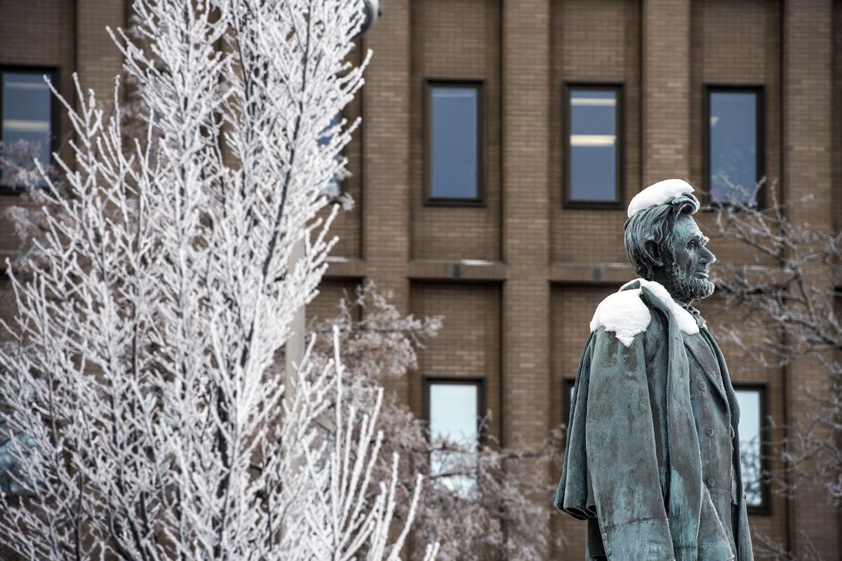 The Bronze statue of Abraham Lincoln in downtown Spokane, Wash, features a snow haircut, Dec. 14, 2016. (Dan Pelle / The Spokesman-Review)