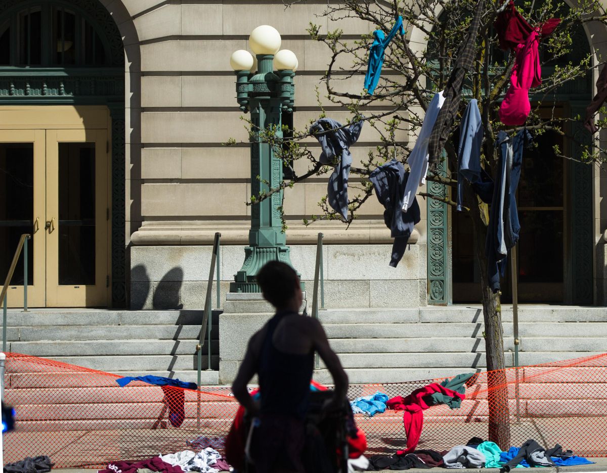 Sweatshirts and warmups hang from trees near the start of Bloomsday 2017 on Sunday, May 7, 2017, in Spokane. (Tyler Tjomsland / The Spokesman-Review)