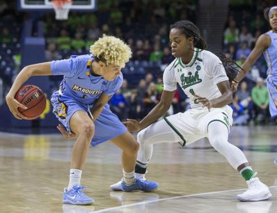 Marquette’s Natisha Hiedeman (5) dribbles between her legs as Notre Dame’s Lili Thompson (1) defends during the second half of an NCAA college basketball game Wednesday, Dec. 20, 2017, in South Bend, Ind. Notre Dame won 91-85 in overtime. (Robert Franklin / Associated Press)