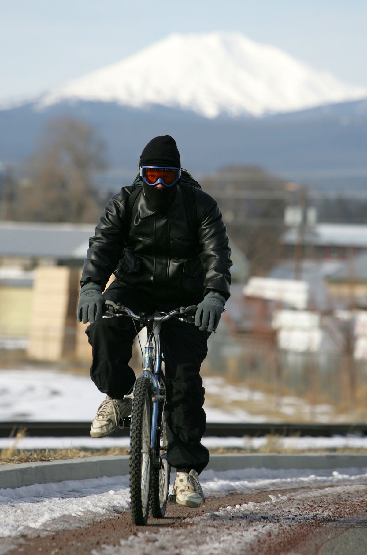 Despite the weather still being cold and damp, many more people could be biking to work and school if gas prices continue to rise. (Associated Press)