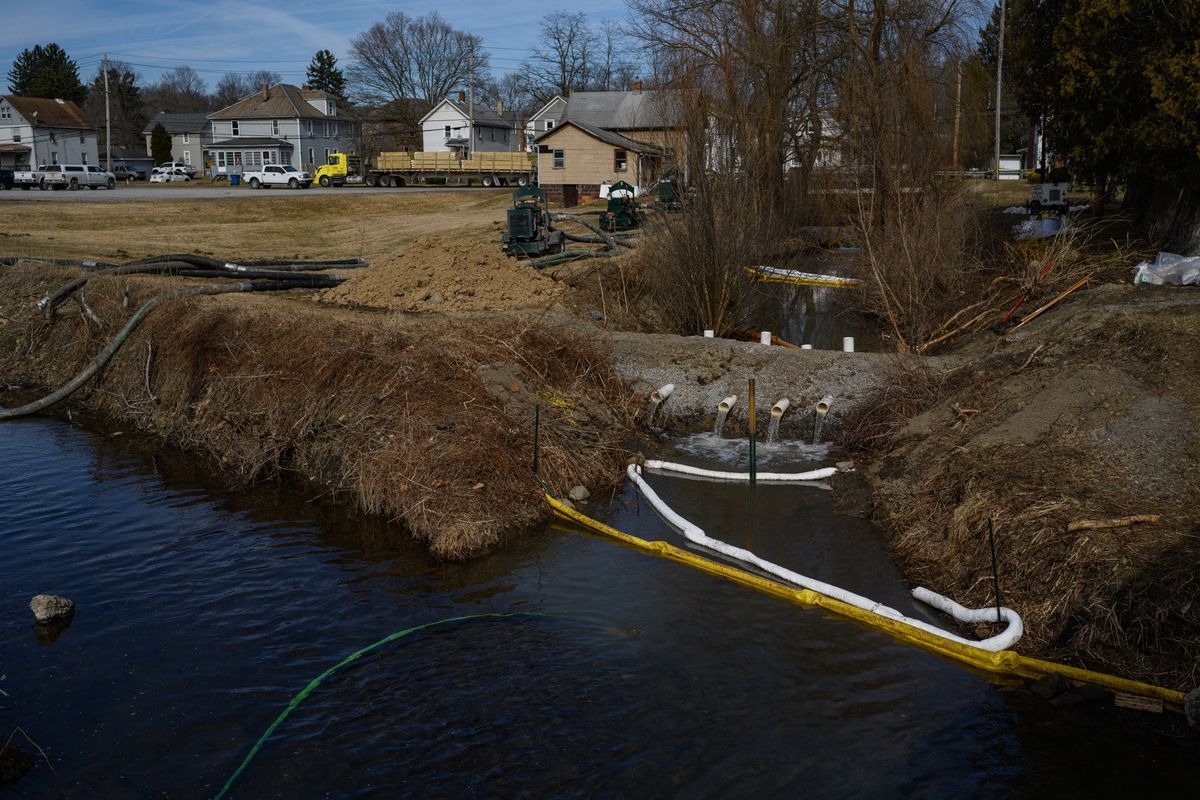 A dam has been installed in a creek next to the city park in East Palestine, Ohio, as crews work to control a chemical spill.  (Rebecca Kiger/For The Washington Post)