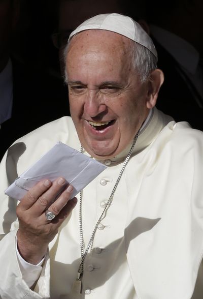 Pope Francis holds a letter from a child as he speaks to people at the Acosta Nu pediatric hospital in San Lorenzo, on the outskirts of Asuncion, Paraguay, Saturday. (Associated Press)