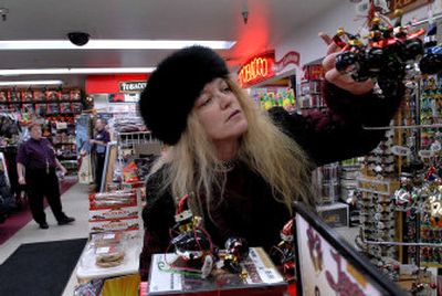 
Tricia Somogyi of Spokane looks at a few Christmas ornaments at Flying J Travel Plaza in Post Falls. The business is open 24 hours a day, seven days a week. 
 (Kathy Plonka / The Spokesman-Review)