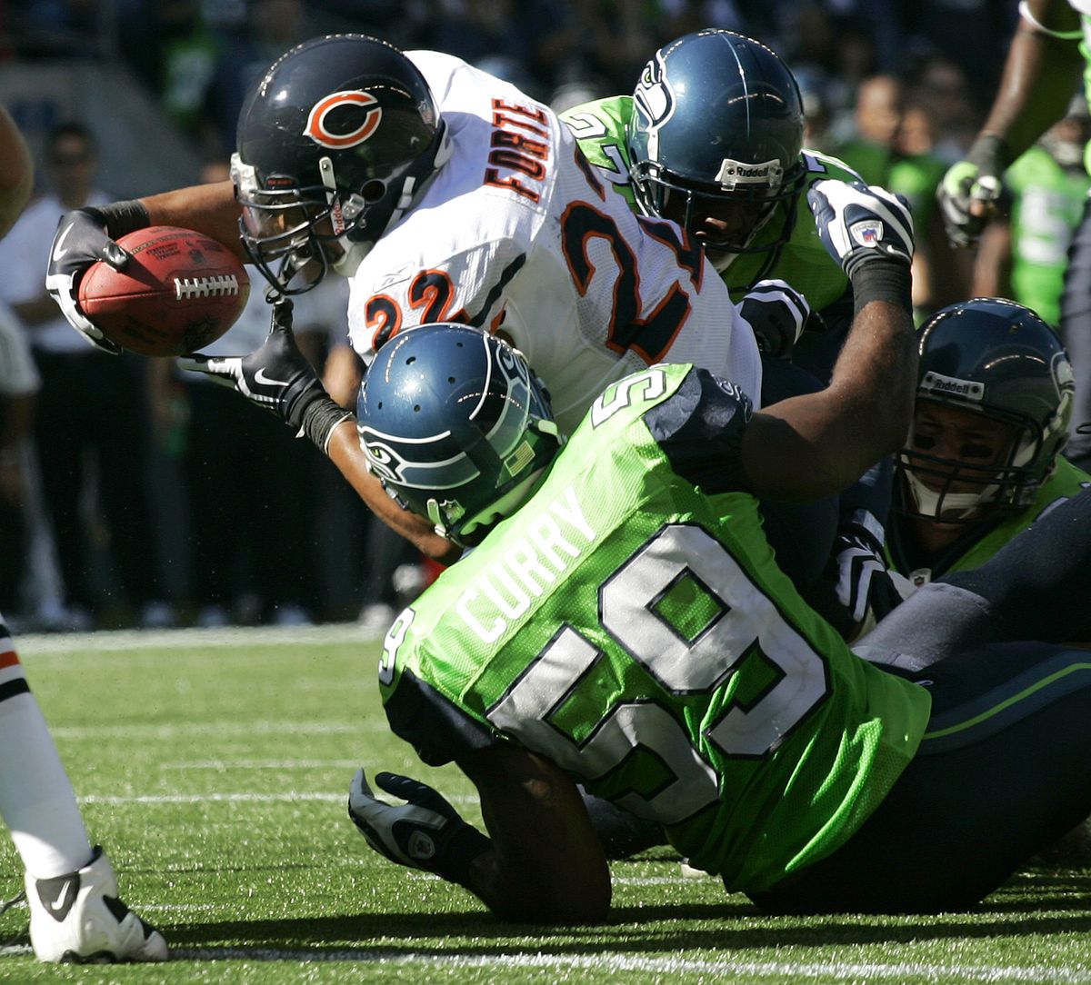 First called a fumble, Chicago’s Matt Forte is ruled down by contact on a play that led to Chicago’s first touchdown late in the second quarter. Associated Press photos (Associated Press photos / The Spokesman-Review)