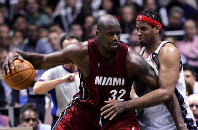 
Miami's Shaquille O'Neal dribbles against New Jersey's Jason Collins during the fourth quarter Friday night. 
 (Associated Press / The Spokesman-Review)