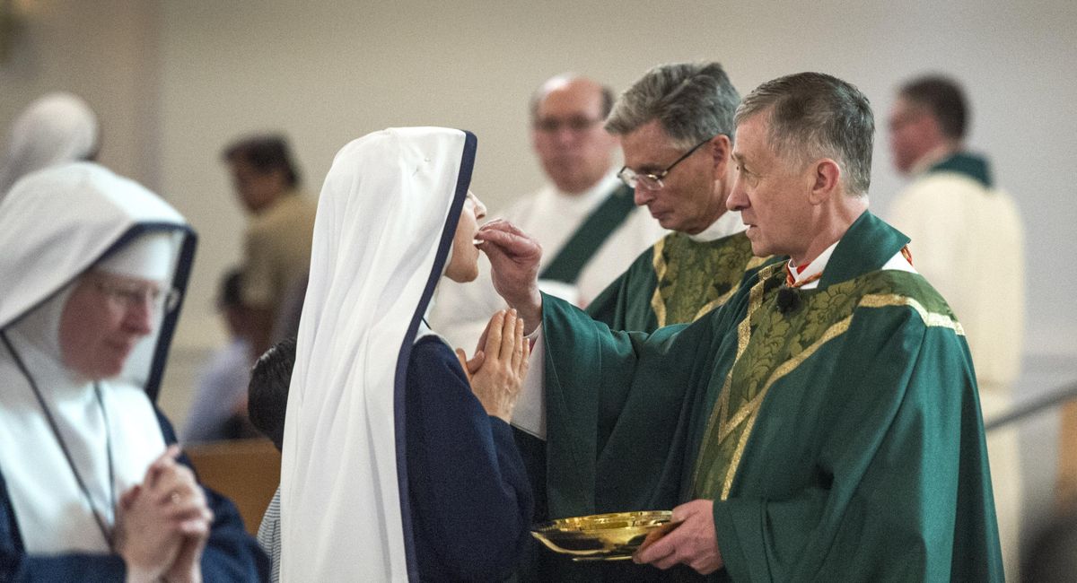 Cardinal Blase Cupich offers Holy Communion during Sunday Mass, Sept. 24, 2017, at the Cathedral of Our Lady of Lourdes. (Dan Pelle / The Spokesman-Review)