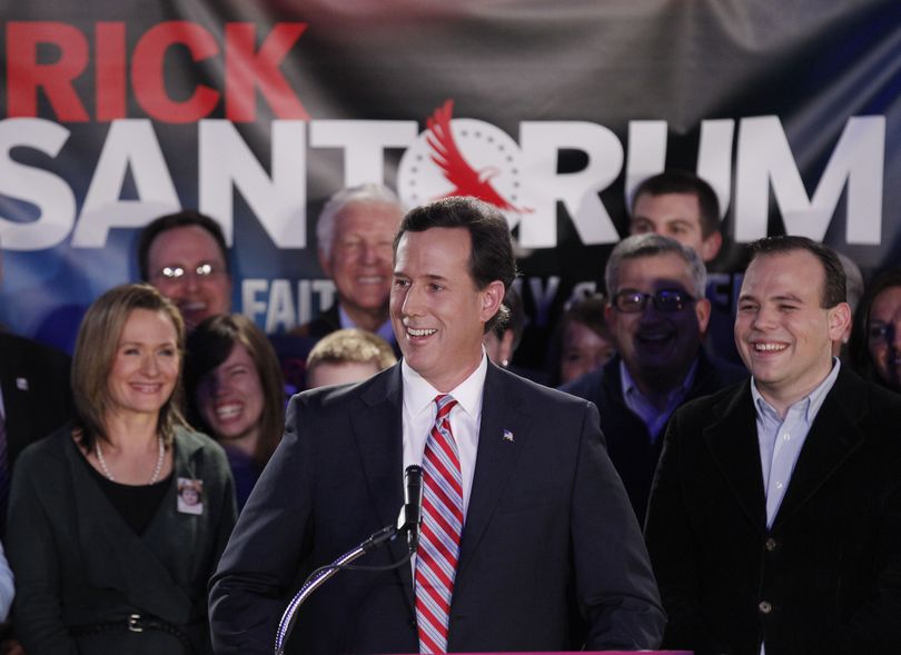 Republican presidential candidate, former Pennsylvania Sen. Rick Santorum, joined by wife Karen, left, addresses supporters at his Iowa caucus victory party Tuesday, Jan. 3, 2012, in Johnston, Iowa. (Charlie Riedel / Associated Press)