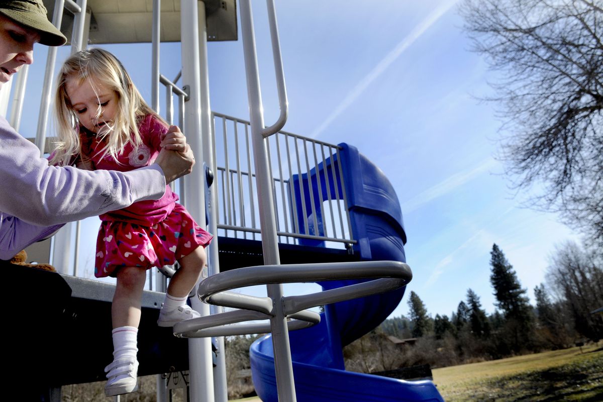 “We moved into this neighborhood because of this park,” said Trista Groshon as she played with her daughter Zoe at Pine River Park in Spokane County on Monday.  A tight budget is forcing cutbacks, including the closure of bathrooms at Pine River and certain others. (Kathy Plonka)