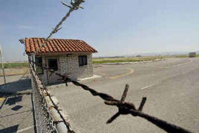 
Barbed wire surrounds an old guard station at an entrance to the closed Marine Corps Air Station El Toro last week. 
 (Associated Press / The Spokesman-Review)
