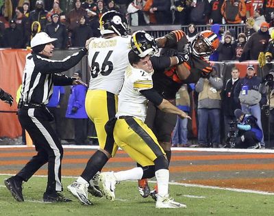 Cleveland Browns defensive end Myles Garrett (95) hits Pittsburgh Steelers quarterback Mason Rudolph (2) with a helmet on Nov. 14 in Cleveland. (Joshua Gunter, cleveland.com / Associated Press)