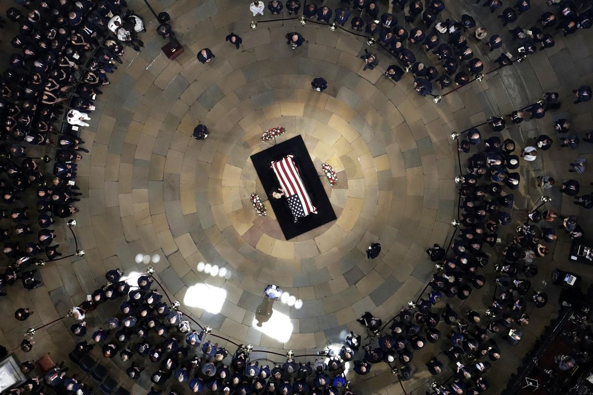 Cindy McCain, wife of Sen. John McCain, R-Ariz., stands over his casket as he lies in state in the U.S. Capitol Rotunda Friday, Aug. 31, 2018, in Washington. (Morry Gash / Associated Press)