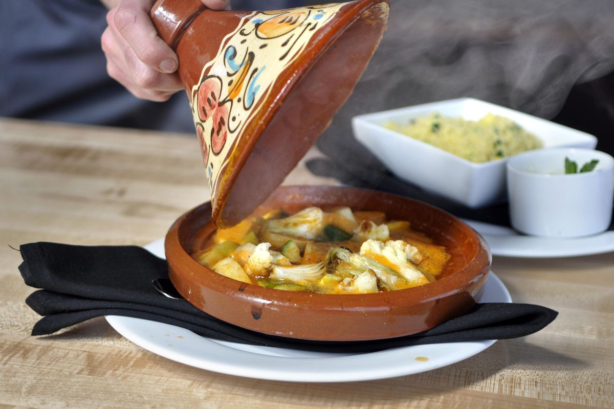 Chef Philip Stanton lifts the lid on his Seven Vegetable Tagine at the Park Lodge. His new restaurant opens Friday, April 27, 2018, in Kendall Yards. (Adriana Janovich / The Spokesman-Review)