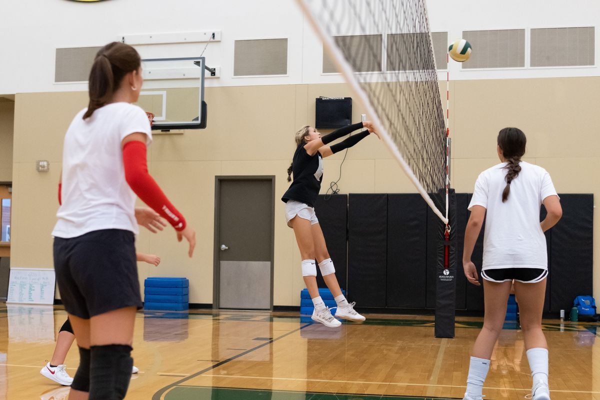 Shadle Park junior middle hitter Abbey Flerchinger sets the ball across the net during a drill Aug. 30 at Shadle Park High School.  (Madison McCord/For The Spokesman-Review)