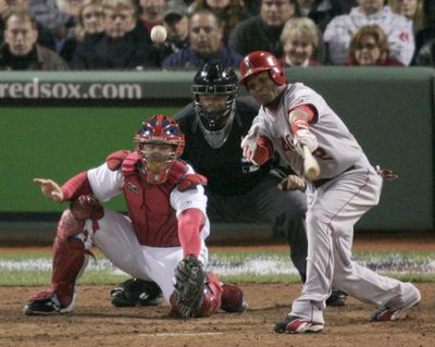 Erick Aybar drives in the winning run in the 12th. (Associated Press / The Spokesman-Review)